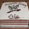 The ST-010 Wrestling cake is rectangular and decorated as a wrestling ring with red ropes, black corner posts, the WWE logo, and "Happy 5th Birthday Cole" written in black and red icing.