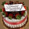 FD-007 is a round cake adorned with chocolate-dipped strawberries, chocolate shavings, a red ribbon, a “Happy Fathers Day” cursive sign on top, and finished with a small decorative razor.