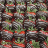 CO-036 Chocolate dipped Strawberries with white drizzle: Fresh strawberries with green tops, dipped in dark chocolate and finished with a white chocolate drizzle, neatly arranged in a tray.