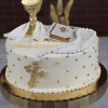 The RC-001G is a round white cake with gold accents, a rosary, gold cross, chalice with host, white cloth, small Bible with gold cross, and "God Bless" on top, displayed on a gold cake stand.