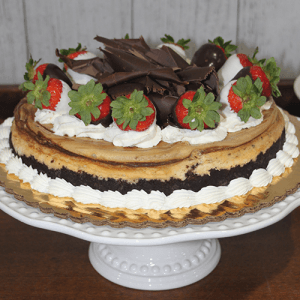 The GD-005 Marble cheesecake features a chocolate crust, whipped cream, whole strawberries—some dipped in chocolate—and chocolate shavings, elegantly displayed on a white cake stand.