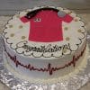 The GC-050A is a round cake featuring a pink nurse scrub top labeled RN, stethoscope, gold dots, "Congratulations," and a red heartbeat line on the side. The cake is presented on a silver board.