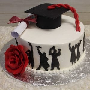 GC-037A is a round white graduation cake decorated with a red rose, a diploma, and a black cap. Silhouettes of graduates in caps and gowns are piped around the side.
