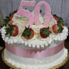 The BD-000E is a decorated cake featuring strawberries, white frosting, a pink ribbon, and large pink "50" toppers—perfect for celebrating a 50th anniversary or birthday.