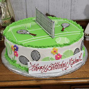 ST-014 is a round birthday cake featuring a tennis court, rackets, and tennis balls on top, colorful flowers on the sides, and a "Happy Birthday Mikhail" sign.