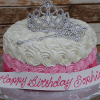 The CB-018E is a round cake with white and pink rosette frosting, finished with a silver tiara and wand. A front banner displays “Happy Birthday Sophia” in pink icing.