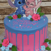 The CB-010G is a pink and blue birthday cake with blue icing drips, decorated with pink and blue flowers, green leaves, cartoon cutouts of Stitch and Angel on top, and "Happy Birthday Ava" written in pink icing.