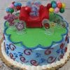 SC-067 Blues Clues: Blue’s Clues-themed cake featuring Blue sitting on a red chair, blue icing with red swirls, green frosting top, and decorated with balloons and character toppers.