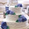 The WD-283 is a three-tiered white wedding cake with textured icing, purple flower accents, green leaves, and a gold "Mr & Mrs Christophe" topper. Other cakes appear blurred in the background.