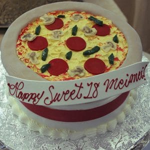 The CB-028C cake is round and decorated to resemble a pepperoni pizza with mushrooms and green peppers, topped with a red and white ribbon that reads "Happy Sweet 18 Meimei!" in red icing.