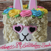 The CB-012D is a llama-themed birthday cake featuring colorful frosting flowers, pink heart-shaped sunglasses, upright ears, and "Happy 8th Birthday Sophia" written in pink icing.