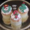 A CH-065 Display Christmas Decor Gold cupcake with chocolate mousse filling is topped with gold icing and holiday-themed decorations for a festive touch.