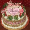A round VC-001 Display Carrot Cake with Valentine’s decor, topped with strawberries and pink icing, a heart-shaped “Happy Valentine’s Day” plaque, “Love” topper, heart-patterned ribbon trim, and nut crumbs on the sides.