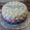 The BD-062 Blue Pink White Rosette is a round cake with swirled white, pink, and blue icing, topped with a white plaque reading "Happy 7th Birthday Arianna" in blue icing, and displayed on a silver cake board.