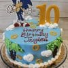 The CB-011C is a round Sonic the Hedgehog-themed birthday cake with blue icing, gold rings, trees, clouds, a Sonic topper, "Happy Birthday Jayden," and a large yellow number 10 decoration.