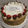 A round BD-008C Carrot cake with white frosting, crushed nuts on the sides, and strawberries dipped in white chocolate. A white card on top says “Happy Birthday mom” in elegant script.