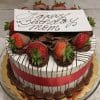 The BD-010 MILK CHOCOLATE DIPPED STRAWBERRY DECOR is a round cake adorned with chocolate, strawberries, and a red ribbon, finished with a white chocolate plaque reading "Happy Birthday Mom" in script atop a gold cake board.