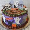 The HW-002 is a round purple and brown birthday cake topped with tombstones, ghosts, skulls, pumpkins, and “Happy Birthday Meredith” in orange icing; some decorations feature “RIP.”.